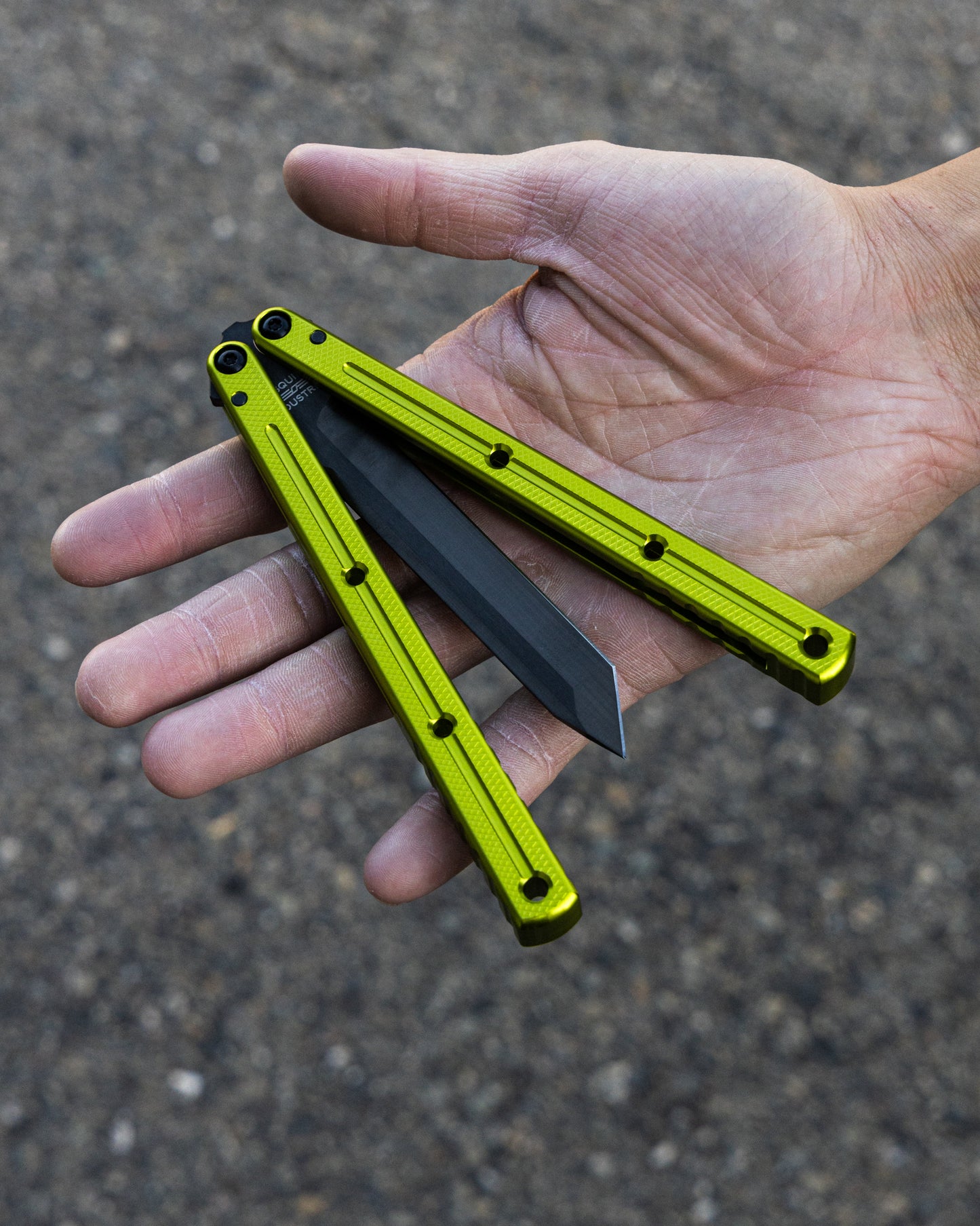 Inked Electric lime tanto krake raken semi close position on hand asphalt background