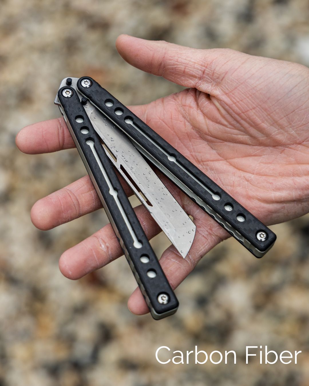 Tanto_Carbon_Fiber_Nautilus Semi Closed On Hand Blurry Background
