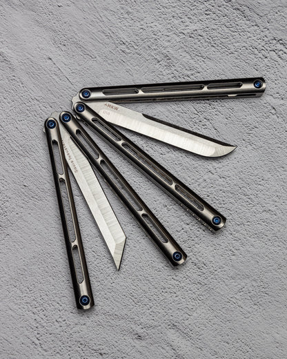 AMKW Tsuami Tanto and Classic Blade Half Open on Gray Surface